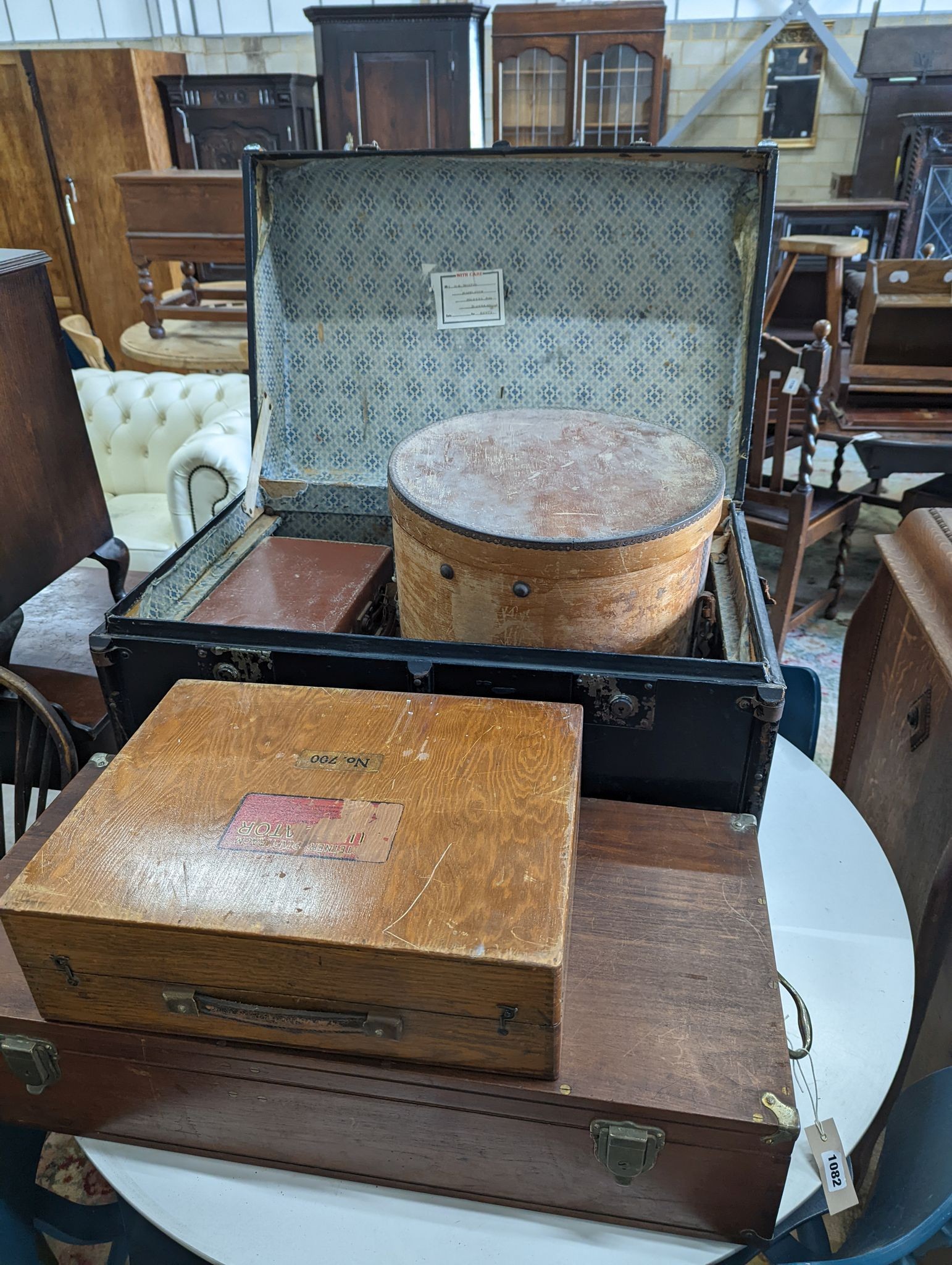 A vintage iron bound wooden travelling trunk, a suitcase, hat box, an artist travel case, and green baize compartments and a small attache case (6)